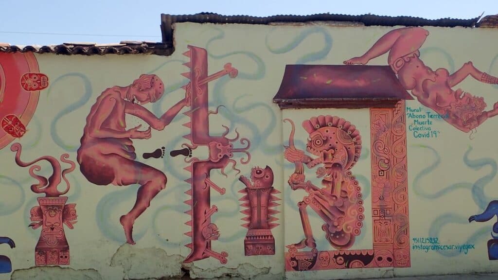 mural with stylized pink figures in pain. "muerte collectiva Covid 19"