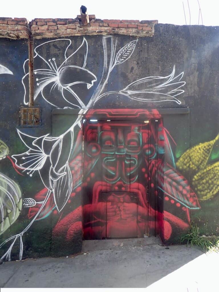 doorway and surrounding wall painted with stylized traditional god