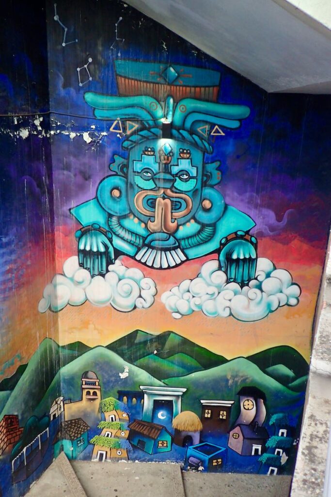 mural with stylized traditional god over village